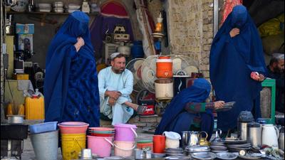 Women look at household items at a stall in a market in Kandahar, Afghanistan on Wednesday. Economic sanctions against Afghanistan must end and unilateral restrictions should be lifted as soon as possible, Chinese state councillor and foreign minister Wang Yi has said. (AFP) Women look at household items at a stall in a market in Kandahar, Afghanistan on Wednesday. Economic sanctions against Afghanistan must end and unilateral restrictions should be lifted as soon as possible, Chinese state councillor and foreign minister Wang Yi has said. (AFP)