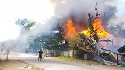 People attempting to extinguish a fire as houses burn in Namg Kar village in Magwe region's Gangaw township, as fighting continues between the Myanmar military and protesters against the military coup. (AFP) People attempting to extinguish a fire as houses burn in Namg Kar village in Magwe region's Gangaw township, as fighting continues between the Myanmar military and protesters against the military coup. (AFP)