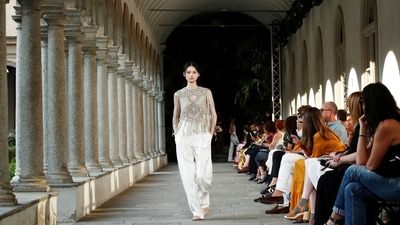 Models dolled up in macs, colourful short halterneck dresses, fringed crochet tops and floaty shirts in sandy colours with wide-leg trousers marked the Alberta Ferretti show.&nbsp; (REUTERS/Alessandro Garofalo)