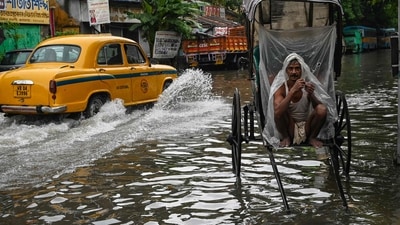 A rickshaw-puller wraps himself with plastic sheet while waiting to ferry customers across a waterlogged streets of Kolkata. (AFP) A rickshaw-puller wraps himself with plastic sheet while waiting to ferry customers across a waterlogged streets of Kolkata. (AFP)