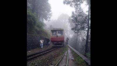 The rail car that derailed on the world heritage Kalka-Shimla narrow-gauge line near Barog amid heavy rain on Thursday morning. (HT Photo)