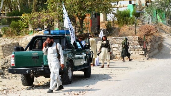 Taliban members inspect near the site of a blast in Jalalabad. Taliban members inspect near the site of a blast in Jalalabad.