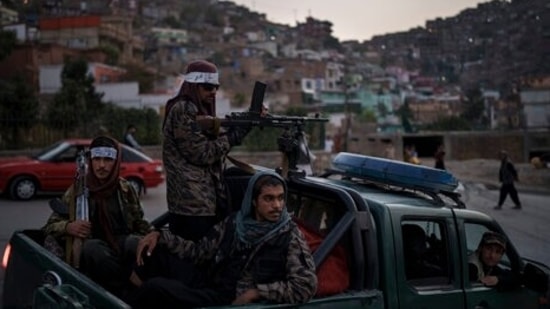 Taliban fighters sit on the back of a pickup truck as they stop on a hillside in Kabul, Afghanistan.(AP) Taliban fighters sit on the back of a pickup truck as they stop on a hillside in Kabul, Afghanistan.(AP)
