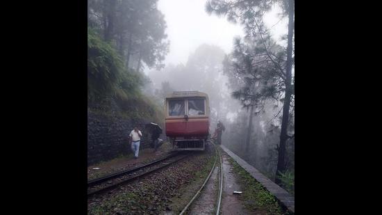 The rail car that derailed on the world heritage Kalka-Shimla narrow-gauge line near Barog amid heavy rain on Thursday morning. (HT Photo)