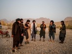 Taliban members enjoy a traditional dance on the banks of a river in Kandahar. Taliban members enjoy a traditional dance on the banks of a river in Kandahar.