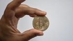 A souvenir coin depicting a Bitcoin (Representational Image / AFP) A souvenir coin depicting a Bitcoin (Representational Image / AFP)
