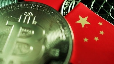A Chinese flag is seen among representations of Bitcoin and other cryptocurrencies.&nbsp; (REUTERS)