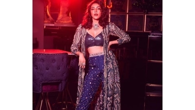 The bling blue bralette top came with a plunging neckline to ooze oomph and flaunting a waistline to die for, Kajal teamed the top with a pair of high-waist blue breezy trousers that sported floral golden embroidery all over. (Instagram/kajalaggarwalofficial) The bling blue bralette top came with a plunging neckline to ooze oomph and flaunting a waistline to die for, Kajal teamed the top with a pair of high-waist blue breezy trousers that sported floral golden embroidery all over. (Instagram/kajalaggarwalofficial)