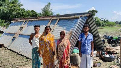 Ful Chand (extreme right) with his mother, wife and younger brother outside the family’s makeshift house on Friday. (Utpal Parashar.)