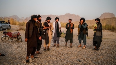 Taliban members enjoy a traditional dance on the banks of a river in Kandahar. (Photo by Bulent Kilic / AFP) Taliban members enjoy a traditional dance on the banks of a river in Kandahar. (Photo by Bulent Kilic / AFP)