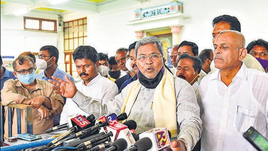Opposition leader in the Karnataka Legislative Assembly and Congress leader Siddaramaiah speaks to media outside the assembly in Bengaluru on Friday. (PTI)