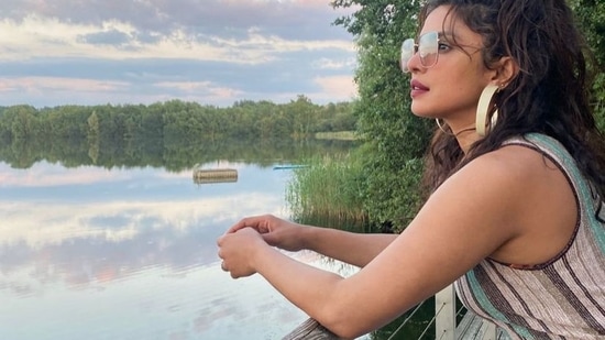 PeeCee was seen making the most of a sunset by the riverside in the next picture where she was dolled up in a cut sleeves dress that came with blue, grey and white straps. Accessorising her boho chic look with a pair of huge white hoop earrings and a pair of blue sunglasses, Priyanka pulled back her tresses into a high ponytail hairstyle.(Instagram/priyankachopra)