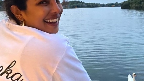 The last picture in the photo album was of the Bollywood star enjoying a lake view with swans floating. Donning a white jersey with her name printed on its back, Priyanka opted for a pair of metallic earrings as she tied her tresses into a messy bun.(Instagram/priyankachopra)
