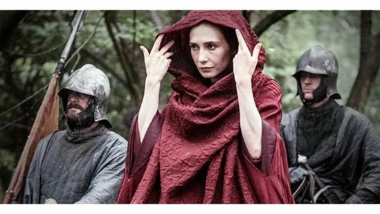 You know nothing Jon Snow. This Game of Thrones character doesn’t need to hide under a hood – she’s already well disguised by the strongest youth filter: magic. She worships a fire god. She has birthed monsters. And she can bring at least one dead person to life. (Answer: Melisandre/The Red Woman)&nbsp;(Credit: HBO)