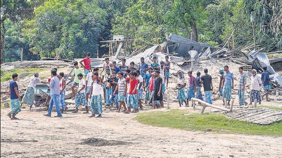 Villagers near their houses which were demolished during an eviction drive, at Gorukhuti in Darrang district, on Friday. The Assam government on Friday ordered a judicial probe into the violence. (PTI) Villagers near their houses which were demolished during an eviction drive, at Gorukhuti in Darrang district, on Friday. The Assam government on Friday ordered a judicial probe into the violence. (PTI)