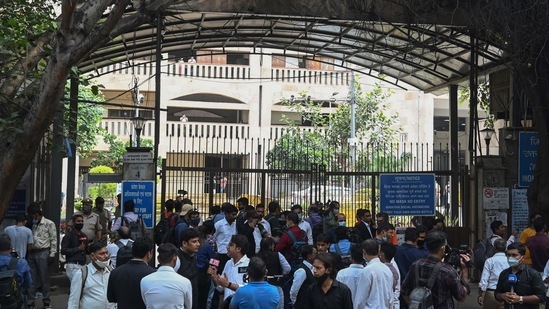 The media gather outside an entrance gate to the Rohini district courtroom in New Delhi on September 24, after a notorious Indian gangster was killed by gunmen dressed as lawyers in a bloody shootout in a courtroom where three people died, local media reported. (AFP)