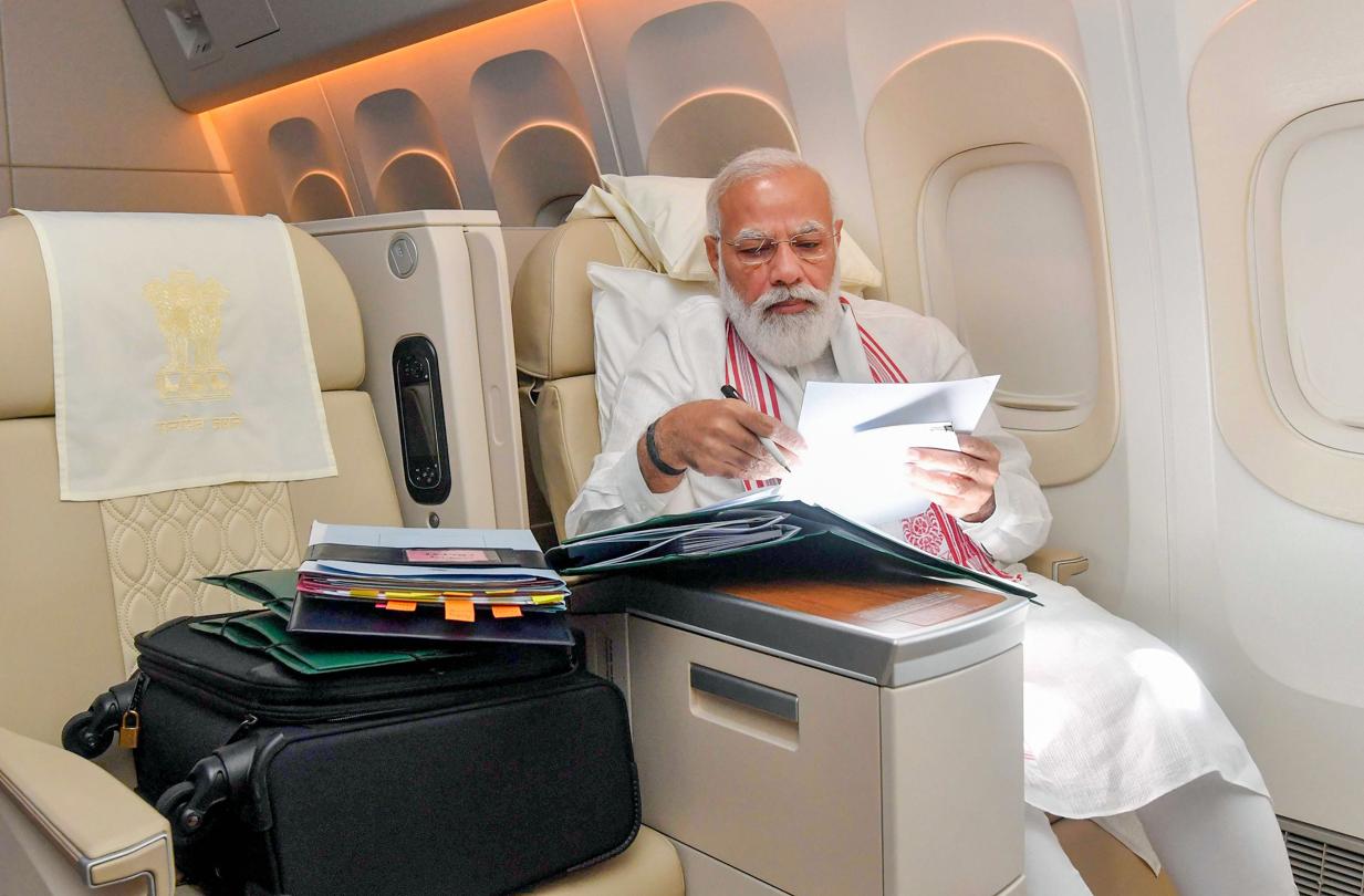 Work mode on: Prime Minister Narendra Modi goes through files during his flight to the United States on September 22, 2021.