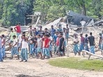 Villagers near their houses which were demolished during an eviction drive, at Gorukhuti in Darrang district, on Friday. (PTI) Villagers near their houses which were demolished during an eviction drive, at Gorukhuti in Darrang district, on Friday. (PTI)