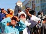 People look up as a body was hung by the Taliban from a crane in the main square of Herat city in western Afghanistan. People look up as a body was hung by the Taliban from a crane in the main square of Herat city in western Afghanistan.
