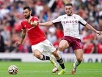 Manchester United's Bruno Fernandes, left, is challenged by Aston Villa's John McGinn during the English Premier League soccer match between Manchester United and Aston Villa at the Old Trafford stadium in Manchester, England, Saturday, Sept 25, 2021.