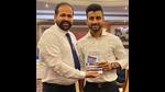 Author Navdeep Singh Gill presenting his book to Manpreet Singh, captain of the Indian hockey team which won a bronze medal at the Tokyo Olympics. (HT photo) Author Navdeep Singh Gill presenting his book to Manpreet Singh, captain of the Indian hockey team which won a bronze medal at the Tokyo Olympics. (HT photo)