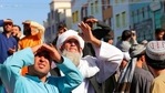 People look up as a body was hung by the Taliban from a crane in the main square of Herat city in western Afghanistan.(AP) People look up as a body was hung by the Taliban from a crane in the main square of Herat city in western Afghanistan.(AP)