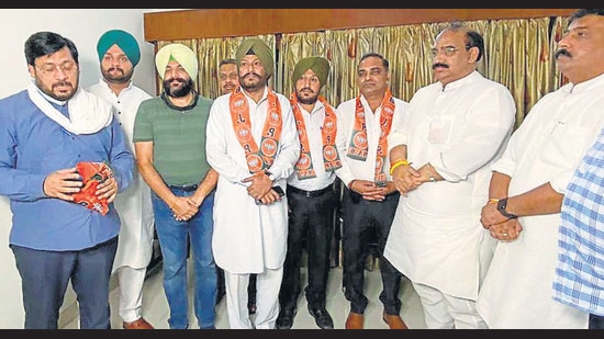 State BJP chief Ashwani Sharma inducting leaders from other parties at Circuit House in Ludhiana on Saturday. (HT Photo)