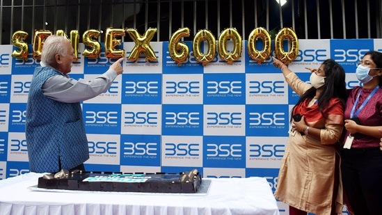 People celebrate outside BSE office as Sensex crosses 60,000 mark for the first time, in Mumbai on Friday.(ANI Photo)