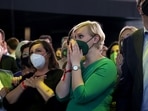 Attendees react to the first exit poll for the German federal election in Berlin, Germany