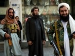 Taliban fighters stand guard on the backdrop of shops selling antiques and decorative merchandise at Chicken Street in Kabul on September 26, 2021. Taliban fighters stand guard on the backdrop of shops selling antiques and decorative merchandise at Chicken Street in Kabul on September 26, 2021. 