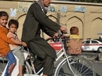 A man along with children rides a bicycle in Kabul (AFP/Image used only for representative purpose) A man along with children rides a bicycle in Kabul (AFP/Image used only for representative purpose)