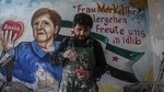 Amsar in front of the mural of Angela Merkel that he painted in March 2020(Anas Alkharboutli/dpa/picture alliance) Amsar in front of the mural of Angela Merkel that he painted in March 2020(Anas Alkharboutli/dpa/picture alliance)