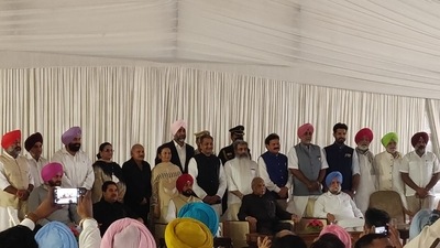 Punjab chief minister Charanjit Singh Channi, Punjab Congress chief Navjot Singh Sidhu and Punjab governor Banwarilal Purohit with new ministers. (Navneet Sharma) Punjab chief minister Charanjit Singh Channi, Punjab Congress chief Navjot Singh Sidhu and Punjab governor Banwarilal Purohit with new ministers. (Navneet Sharma)