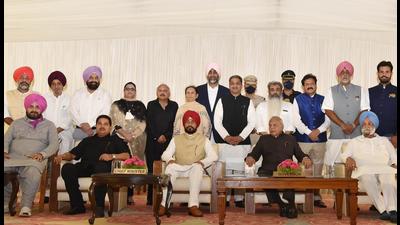 Punjab governor Banwarilal Purohit, chief minister Charanjit Singh Channi, his deputies Sukhjinder Singh Randhawa and OP Soni, and state Congress president Navjot Singh Sidhu with the newly inducted cabinet members in Chandigarh on Sunday. Punjab governor Banwarilal Purohit, chief minister Charanjit Singh Channi, his deputies Sukhjinder Singh Randhawa and OP Soni, and state Congress president Navjot Singh Sidhu with the newly inducted cabinet members in Chandigarh on Sunday.