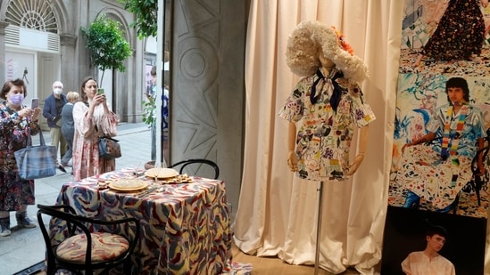 People take pictures of the shop window displaying creations as part of the Arthur Arbesser women's Spring Summer 2022 collection(AP) People take pictures of the shop window displaying creations as part of the Arthur Arbesser women's Spring Summer 2022 collection(AP)