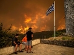 Local residents look at the wildfire approaching the village of Gouves on Evia (Euboea) island, the second largest Greek island on August 8. (Picutre for representation only)(AFP) Local residents look at the wildfire approaching the village of Gouves on Evia (Euboea) island, the second largest Greek island on August 8. (Picutre for representation only)(AFP)
