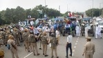 Security personnel stand guard at Noida as Bharatiya Kisan Union (BKU) members participate in farmers' 'Bharat Bandh' against the Centre's three farm reform laws, (PTI Photo)(PTI) Security personnel stand guard at Noida as Bharatiya Kisan Union (BKU) members participate in farmers' 'Bharat Bandh' against the Centre's three farm reform laws, (PTI Photo)(PTI)