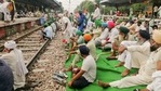 Farmers block the train tracks at a railway station during their' 'Bharat Bandh' against central government's three farm reform laws, in Bahadurgarh. (PTI Photo) Farmers block the train tracks at a railway station during their' 'Bharat Bandh' against central government's three farm reform laws, in Bahadurgarh. (PTI Photo)