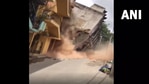 A video circulated on social media showed the dramatic collapse of the three-storey building. (Screengrab from ANI video) A video circulated on social media showed the dramatic collapse of the three-storey building. (Screengrab from ANI video)