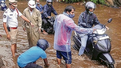 People wade through a flood affected area following heavy rains induced by Cyclone Gulab in Visakhapatna (PTI) People wade through a flood affected area following heavy rains induced by Cyclone Gulab in Visakhapatna (PTI)