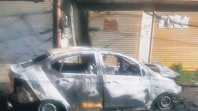 The four occupants jumped out of the car as soon as it caught fire and escaped unhurt. (HT Photo)