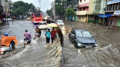 Vehicles wade through a waterlogged road in Hyderabad following heavy rain on Monday. (PTI) Vehicles wade through a waterlogged road in Hyderabad following heavy rain on Monday. (PTI)