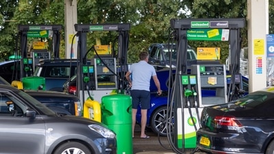 A customer uses a fuel pump at BP Plc petrol station near Guildford, UK. (Bloomberg)