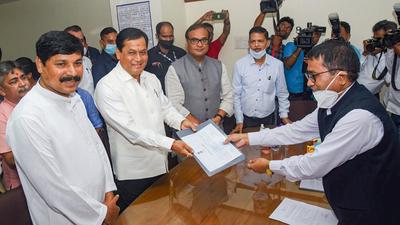 Union minister Sarbananada Sonowal receives a certificate for the Rajya Sabha seat in Guwahati on Monday. Three BJP nominees were unanimously elected to the Upper House. (PTI)