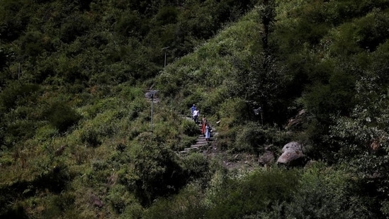 Health workers trek through mountains to vaccinate people, near Malana village in Himachal Pradesh, on September 14. On September 14, a team of five led by district health officer Dr Atul Gupta set out to Malana to administer second vaccine doses for the coronavirus disease (Covid-19).(Adnan Abidi / REUTERS)