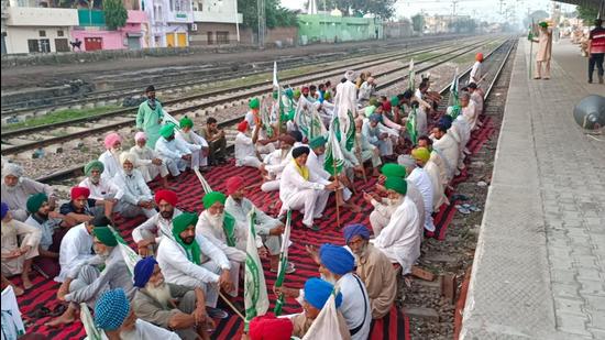 Protesters block the tracks at Barnala railway station in Punjab on Monday in response to the Bharat Bandh called by farmer unions. (HT Photo)