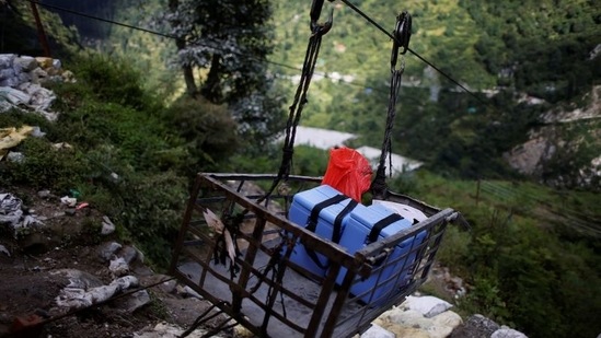 Medical kits and boxes containing Covishield vaccines, are transported on a ropeway trolley to Malana village, in Himachal Pradesh, on September 14. Before beginning the trek to the village, Gupta and his team placed the boxes onto a gondola connected to pulleys to carry the medicine across the river gorge that separates Malana from the road. That lightened their walk considerably as they set off to cross the gorge which drops down about 100 metres (330 feet), Reuters reported.(Adnan Abidi / REUTERS)