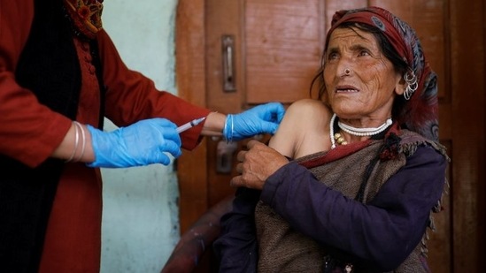 Kamla Devi, 58, a health worker, administers a dose of the Covishield vaccine to a villager, at Malana village in Himachal Pradesh, on September 14. "People were initially scared to take the vaccine, worried they would fall sick or die," village head Rajuram told Reuters. "Then I took it and others also mustered the courage."(Adnan Abidi / REUTERS)