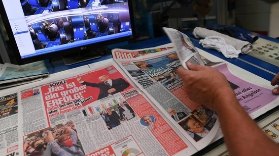 A worker checks a printed edition of Bild newspaper that shows candidate for chancellor Olaf Scholz, of Social Democratic Party (SPD), after the first exit polls for the general elections in Berlin, Germany.&nbsp;(Reuters Photo)