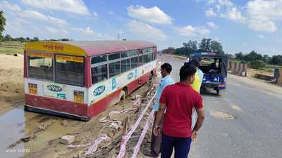 The roadways bus stuck in mud alongside the road in Bewar.